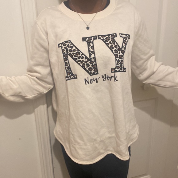 A white sweater with a leopard print sight saying ny - Picture 2 of 5